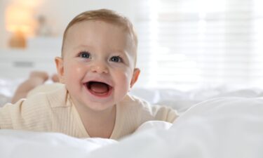 Cute,Little,Baby,On,Bed,At,Home
