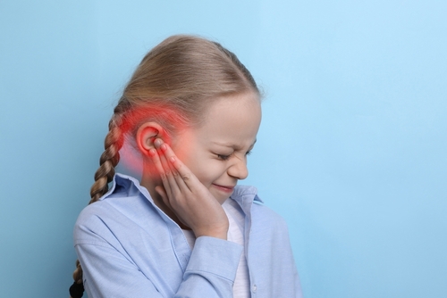 Little,Girl,Suffering,From,Ear,Pain,On,Light,Blue,Background,